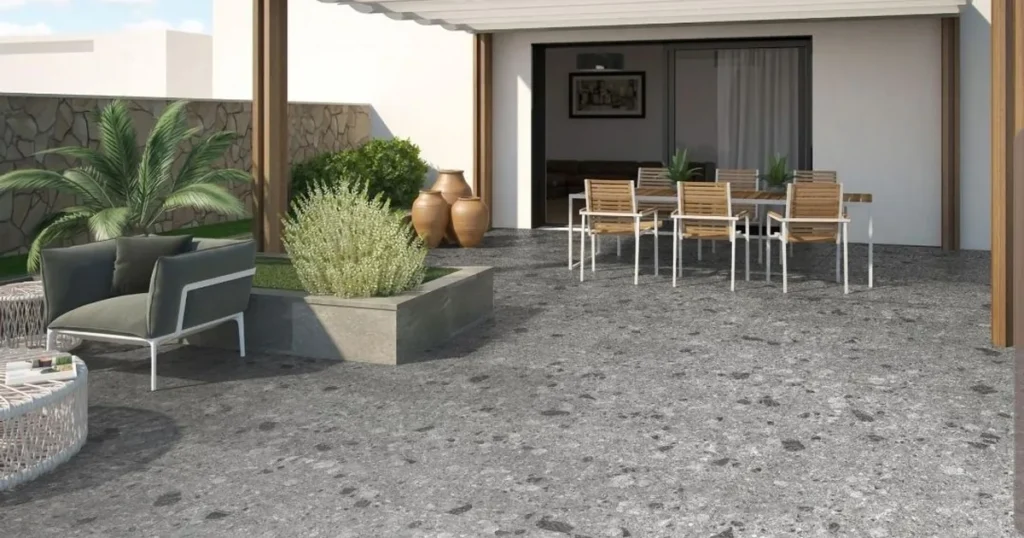Hiên nhà lát gạch Terrazzo tông xám kết hợp cây xanh và bàn ghế gỗ